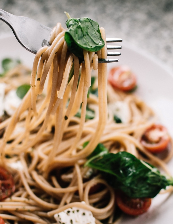 Selective focus photography of pasta with tomato and basil 1279330